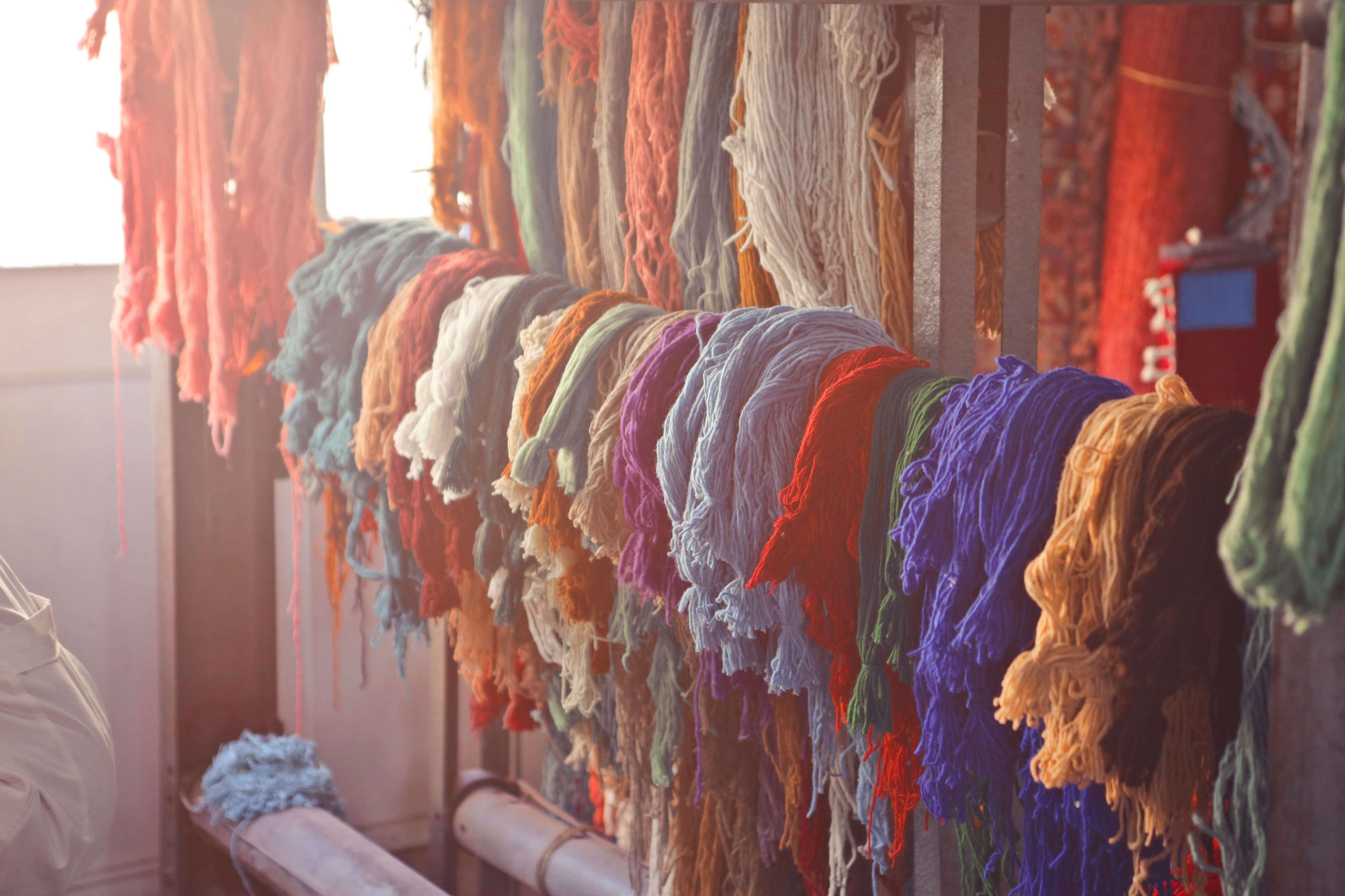 An image showing colourful naturally dyed wool yarn used for making Kilim rugs.